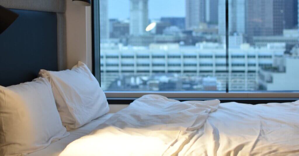 White Pillows on Bed Beside Window